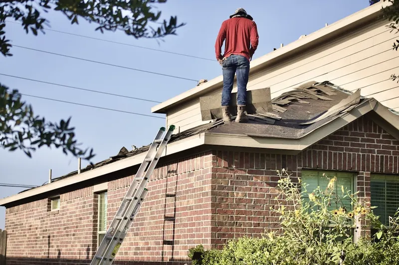 Professional roofer working on a residential roof in McFarland